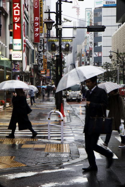 A busy street scene during a rainstorm, Tokyo.